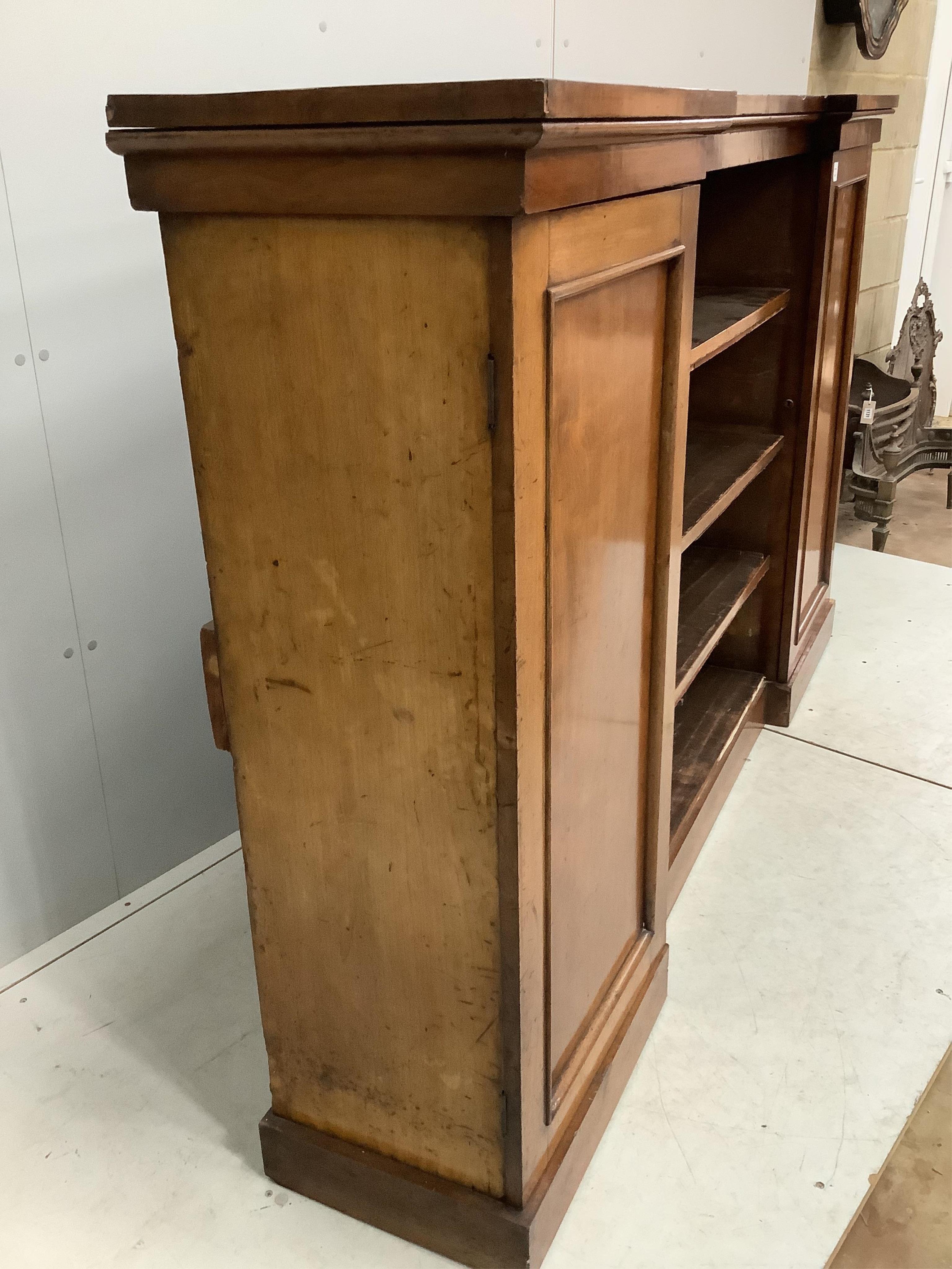 A Victorian mahogany inverted breakfront bookcase cupboard, width 198cm, depth 39cm, height 124cm. Condition - fair, one plinth foot corner split with lost veneer